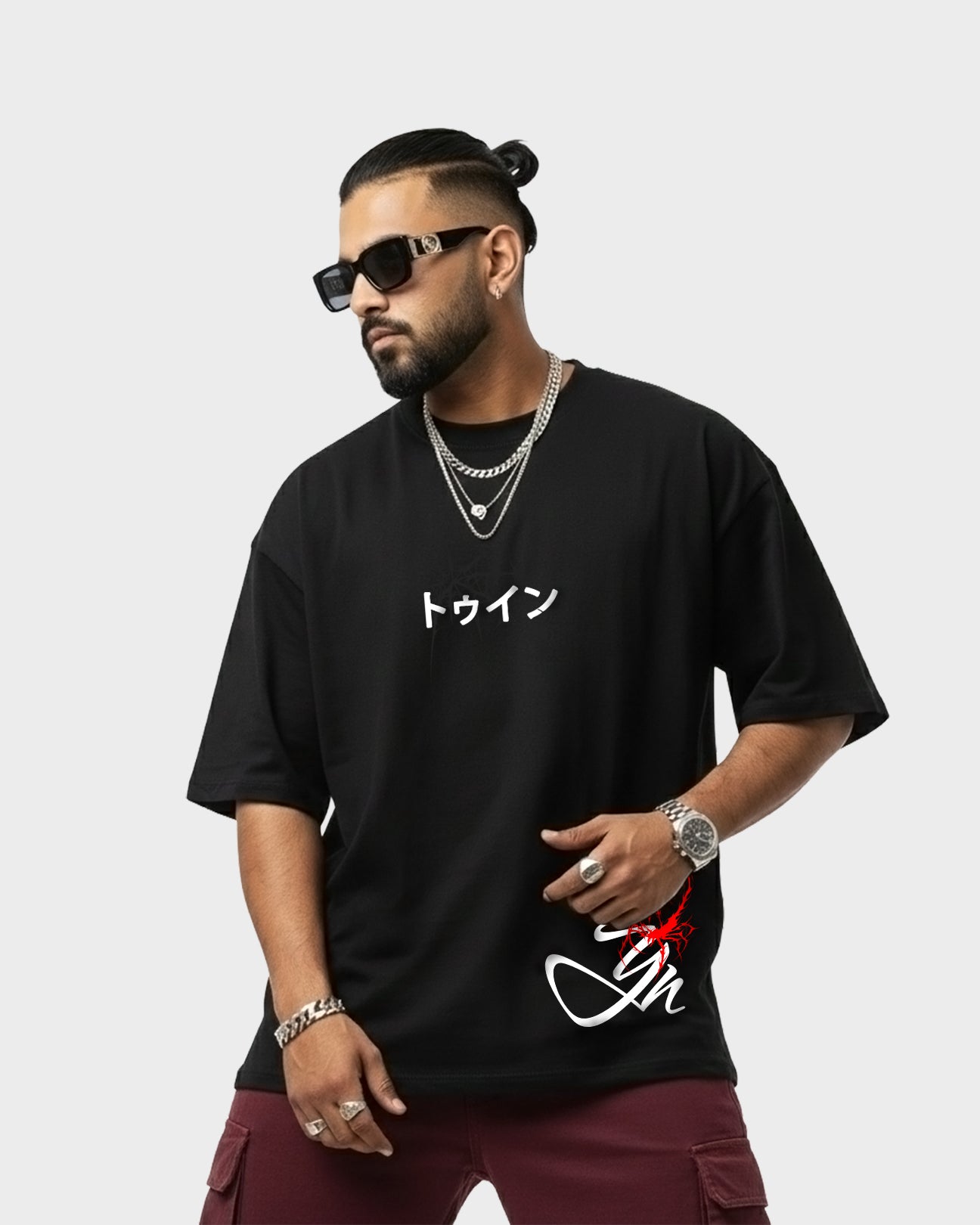 Model wearing TWYN Akai Samurai black oversized t-shirt with red samurai artwork on a light background