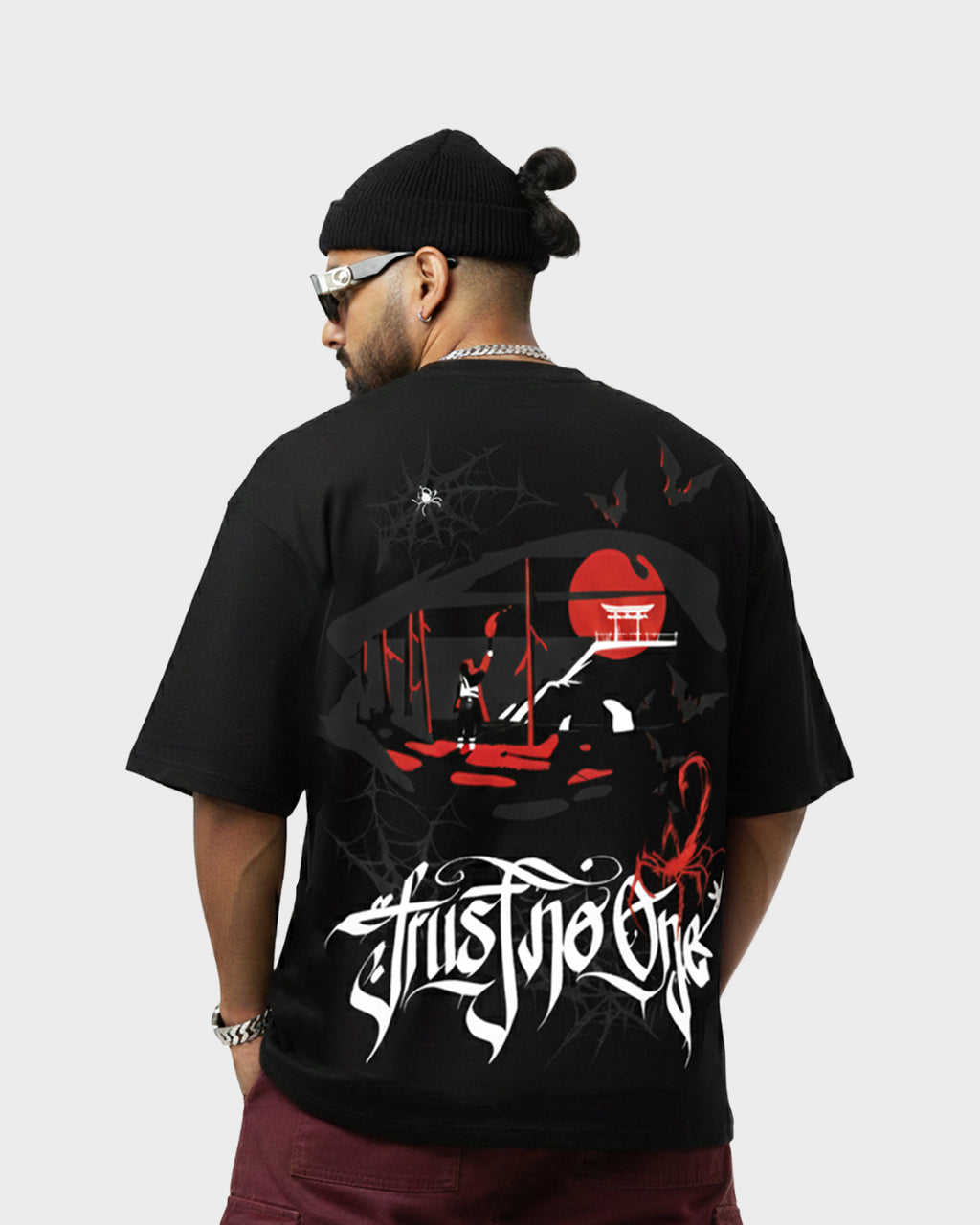 Model showing the back of the TWYN Akai Samurai black oversized t-shirt featuring red sun and samurai scene artwork