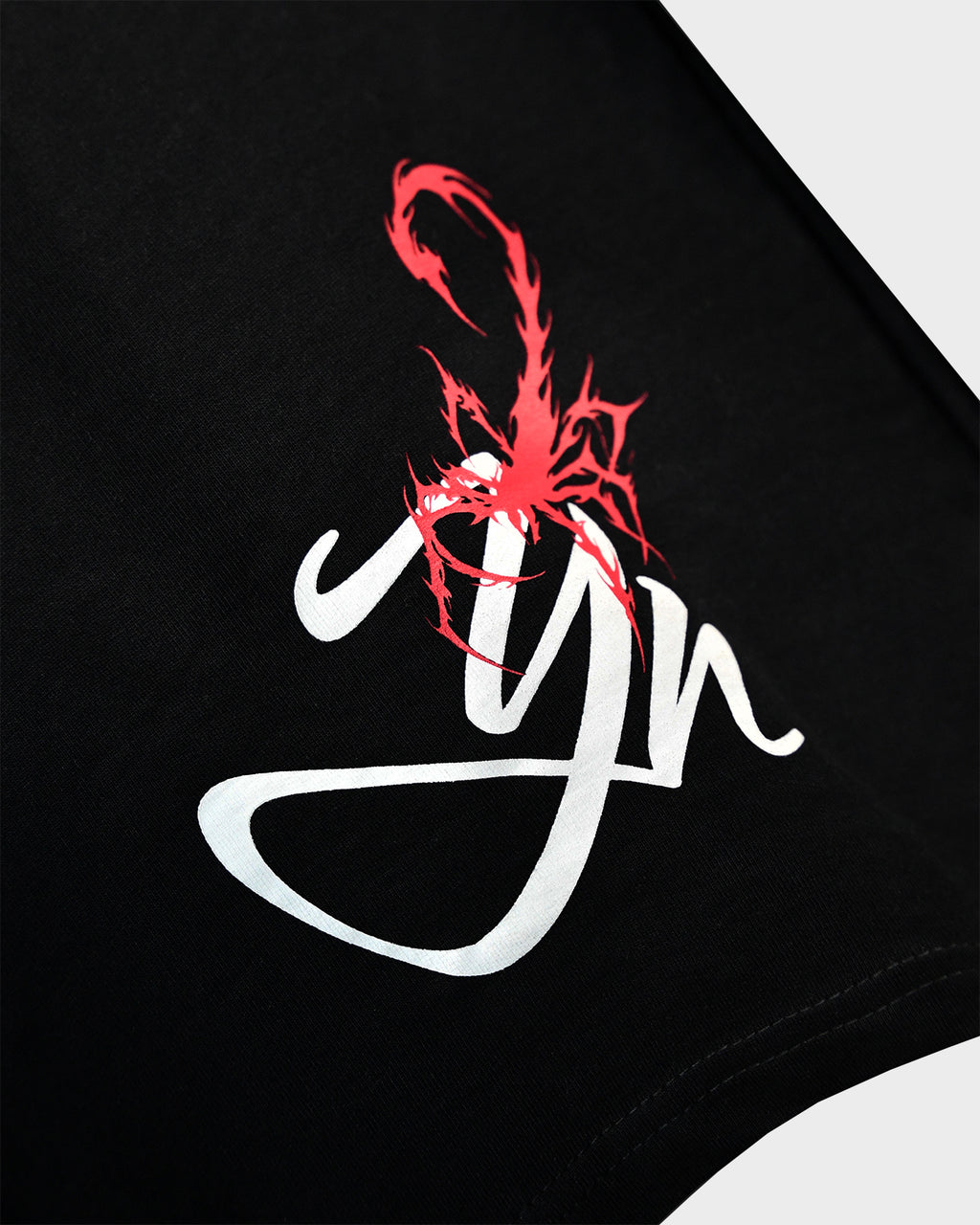 Close-up of TWYN Akai Samurai black t-shirt with red scorpion artwork and white twyn logo