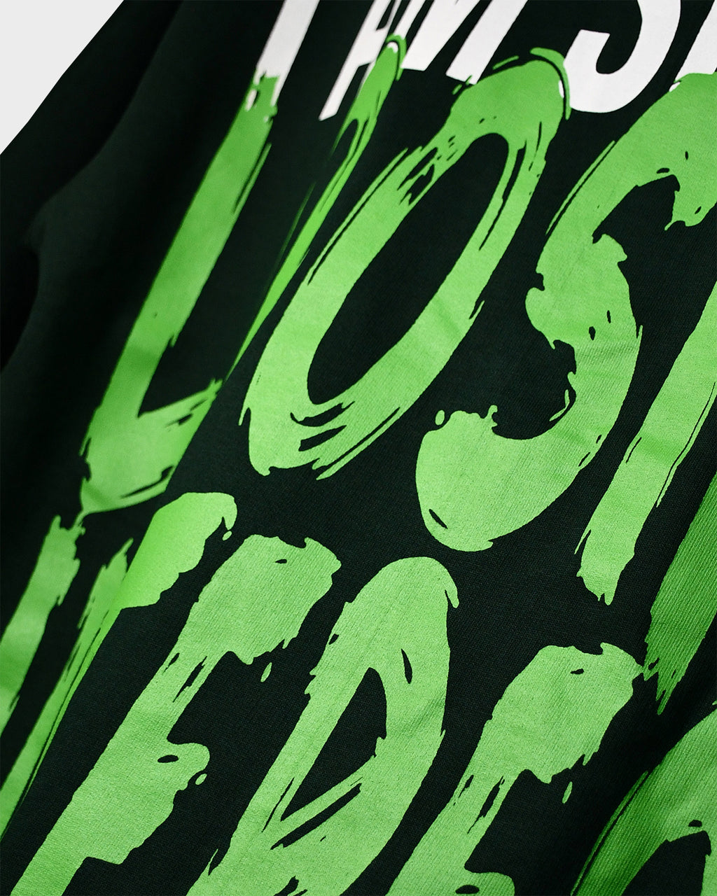 Close-up of TWYN Midori Ascend green oversized t-shirt with bold neon green back print reading ‘I am slowly losing interest on everything