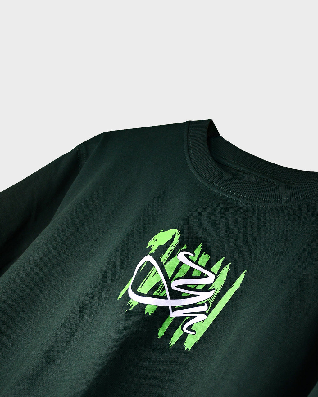 Close-up of TWYN Midori Ascend green oversized t-shirt with neon green claw-mark TWYN logo on the chest