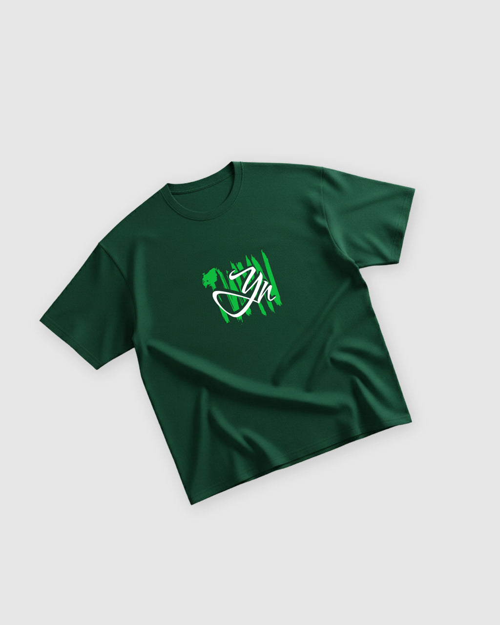 Flat lay of TWYN Midori Ascend green oversized t-shirt with neon green claw-mark TWYN logo on a light background